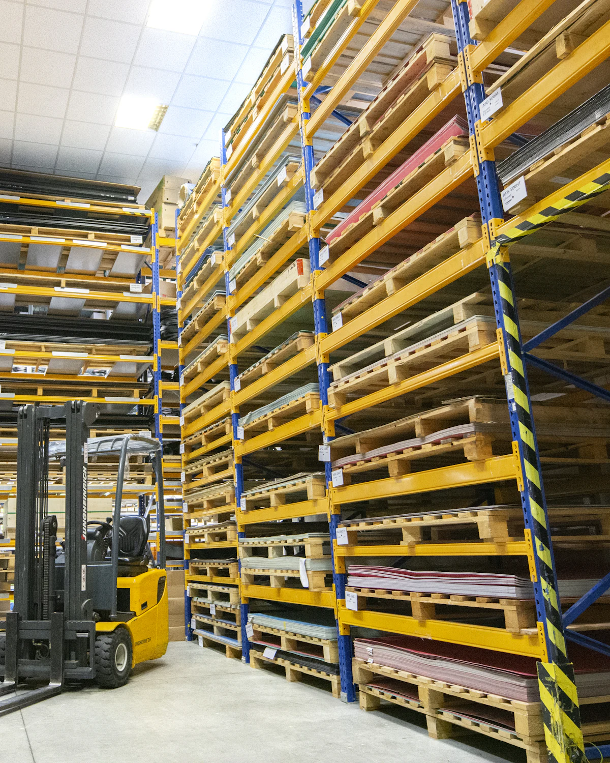 Warehouse aisle stacked with wrapped pallets
