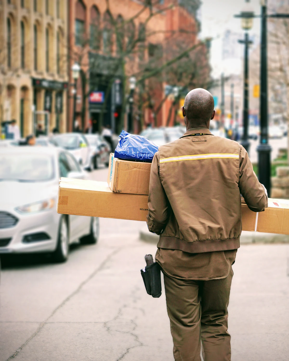 Courier loading parcels beside a delivery vehicle